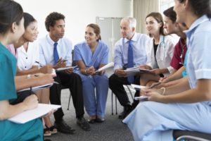 42164328 - medical staff seated in circle at case meeting